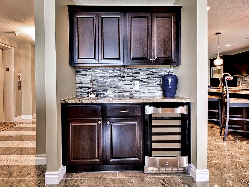 Wet bar has sink and built in wine cooler.